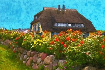 Painted traditional reed roof covered house with cottage garden on island Ruegen