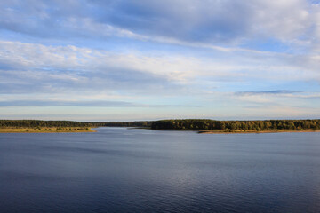 landscape view of the river Volga valley with fields and forest under the cloudy sky