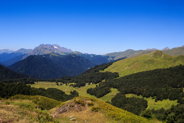 landscape view with rocky mountains covered with snow greenforest and alpine meadows in caucasus mountains