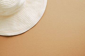 Fototapeta na wymiar Flat lay straw hat on sandy color background. Top view, overhead. Summer, vacation concept