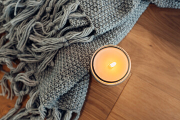 cozy quiet place with a candle and a blanket