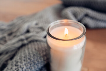 cozy quiet place with a candle and a blanket