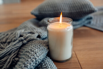cozy quiet place with a candle and a blanket
