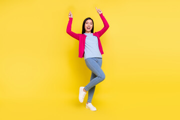 Fototapeta na wymiar Full size photo of impressed brunette young lady dance wear pink sweater jeans isolated on yellow background