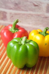 Yellow orange and red capsicum on white background 