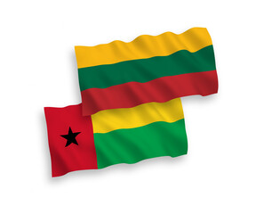 National vector fabric wave flags of Lithuania and Republic of Guinea Bissau isolated on white background. 1 to 2 proportion.