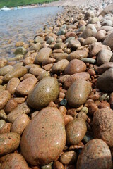 summer sea water transparent surface clear sea brown stone beach 