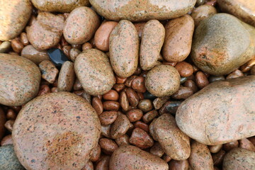 Fototapeta na wymiar brown stones beach summer day