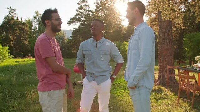 Medium Long Shot Footage Of Modern African American, Middle Eastern And Caucasian Friends Hanging Out Together In Park