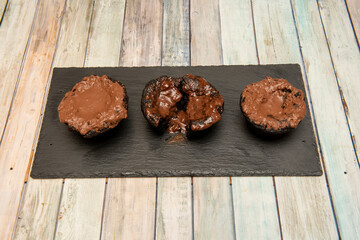 Chocolate brownies and chocolate coulant on black slate plate