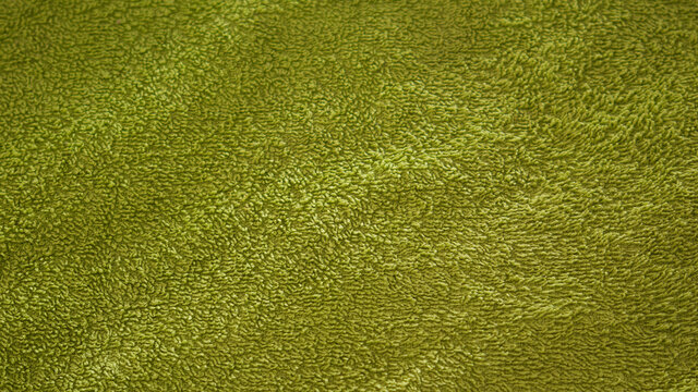 Green fabric textured background close-up