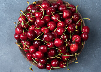 Sweet organic berries in a plate on a concrete background Top view with copy space