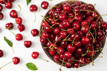 Naklejka na ściany i meble fresh juicy cherries in a wooden bowl Focus on cherries in bowl