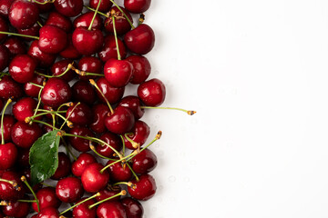 Cherry Red fresh Cherries in white background and a bunch of cherries on the table