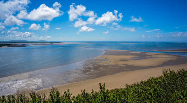 Panoramic shot of LLansteffan beach with clear blue water in southern Wales