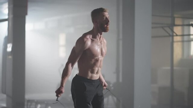 Slow motion: Male athlete skipping rope.