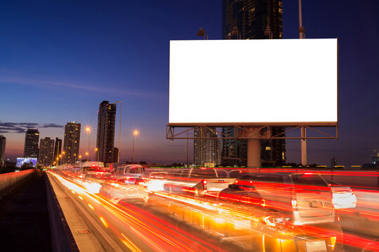 Blank billboard on light trails, street, city and urban in the twilight - can advertisement for display or montage product or business