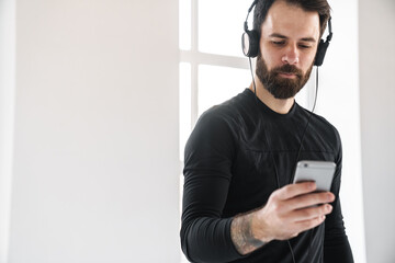 Young brunette bearded white man in sportswear