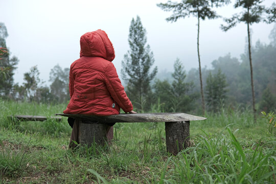 Girl sitting on bench and looking at the nature