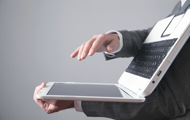 Businessman holding laptop computer in office.