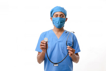 Young indian male Doctor holding stethoscope in hand on white ba