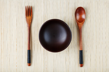 Wooden Spoon, Fork and Plate on a Bamboo Backing.