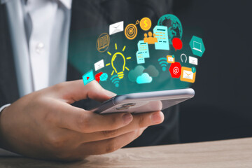 Digital marketing strategy idea concept. Content creator holding a smartphone and great creative idea for target with virtual icon financial reports.