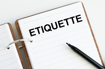 The inscription on the ETIQUETTE notebook on a white background. A business concept.