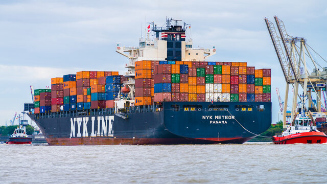 Hamburg, Germany - August 13, 2017: The container ship NYK LINE Meteor is tugged by two tugboats.