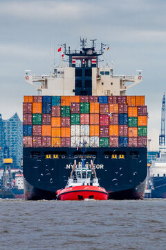 Hamburg, Germany - August 13, 2017: The container ship NYK LINE Meteor is tugged by a tugboat.