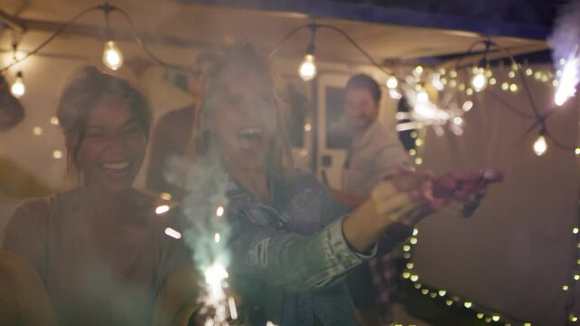 Video of happy friends enjoying while holding sparklers. Shot with RED helium camera in 8K 