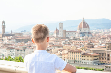 Young boy looking on panoramic view of Florence, Italy. Back view