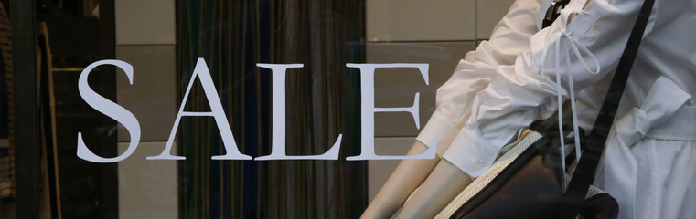 Sale sign at the window shop in the mall	