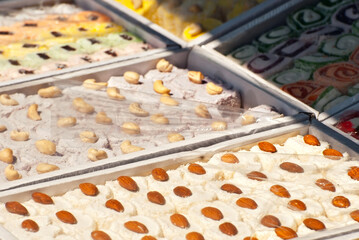 Turkish national sweets are sold at the fair. Multi-colored Asian desserts stacked on the table. Rahat lokum in bulk is sold at the festival.
