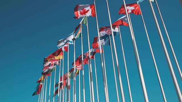Different flags fluttering on flagpoles