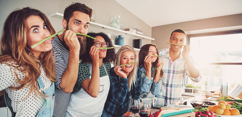 Group of chefs playing with asparagus stalks