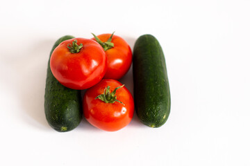 Healthy salad ingredients on white background Tomatoes top view tomatoes and cucumbers top view