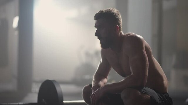 Preparing for the exercise, training. fitness man athlete chalk powder sportsman preparing training workout in gym ready for bodybuilding strength exercise slow motion.