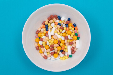 Global Pharmaceutical Industry and Medicinal Products - Different Colored Pills, Tablets and Capsules on Plate Lying on Blue Background, Top View, Flat Lay