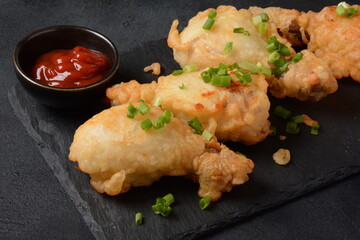 Golden crispy fried chicken drumsticks. Fried chicken pieces lightly battered, deep fried food
