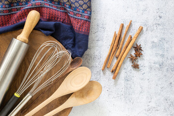 Kitchen utensils and ingredient concept, whisk, wooden spoon and rolling pin with traditional cloth