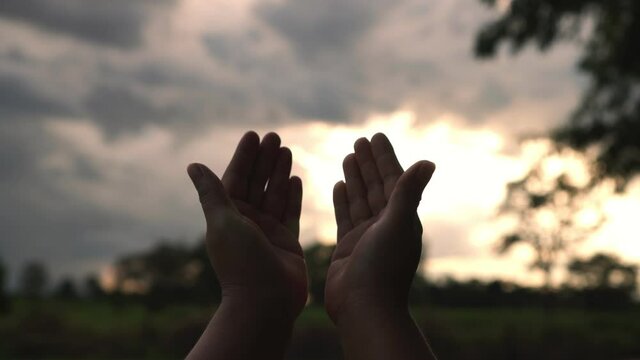 B roll 4k. of Human hands open palm up worship god with sunset like hope. Eucharist Therapy Bless God Helping Repent Catholic Easter Lent Mind Pray. Christian Religion concept background. Victory god.