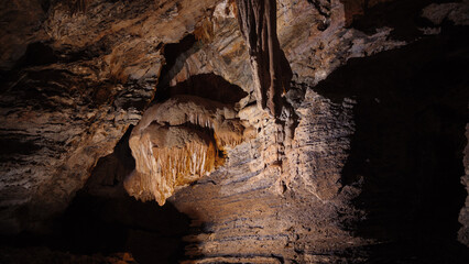 Cave formations within the caverns of Mole Creek, in Tasmania, Australia. Limestone formations with varied lighting and cave river. 