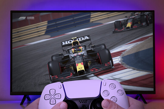 F1 2021 game on TV screen with kid holding game controller. 27 Jul, Sao Paulo, Brazil
