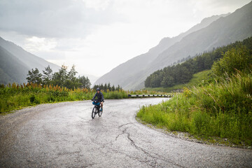 Bicyclist at rainy on the mountain road