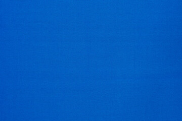 Texture of vibrant light blue flat fabric made of polyester material. Fabric background in light blue tone.