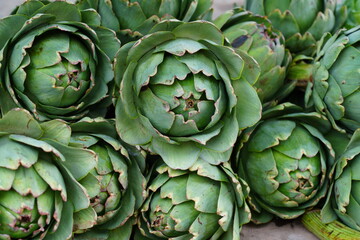 Green and purple artichokes at a French farmers market