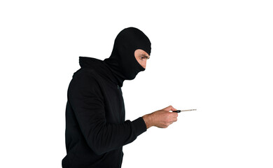 Thief with balaclava tries to open the door of apartment with a key