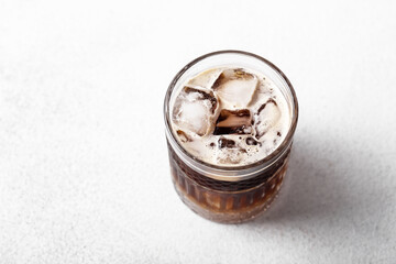 Cold drink with espresso and tonic in glass on white background 