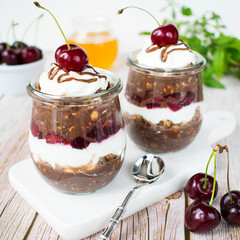 Overnight porridge - Black Forest. Chocolate porridge with yoghurt and cherries in honey.